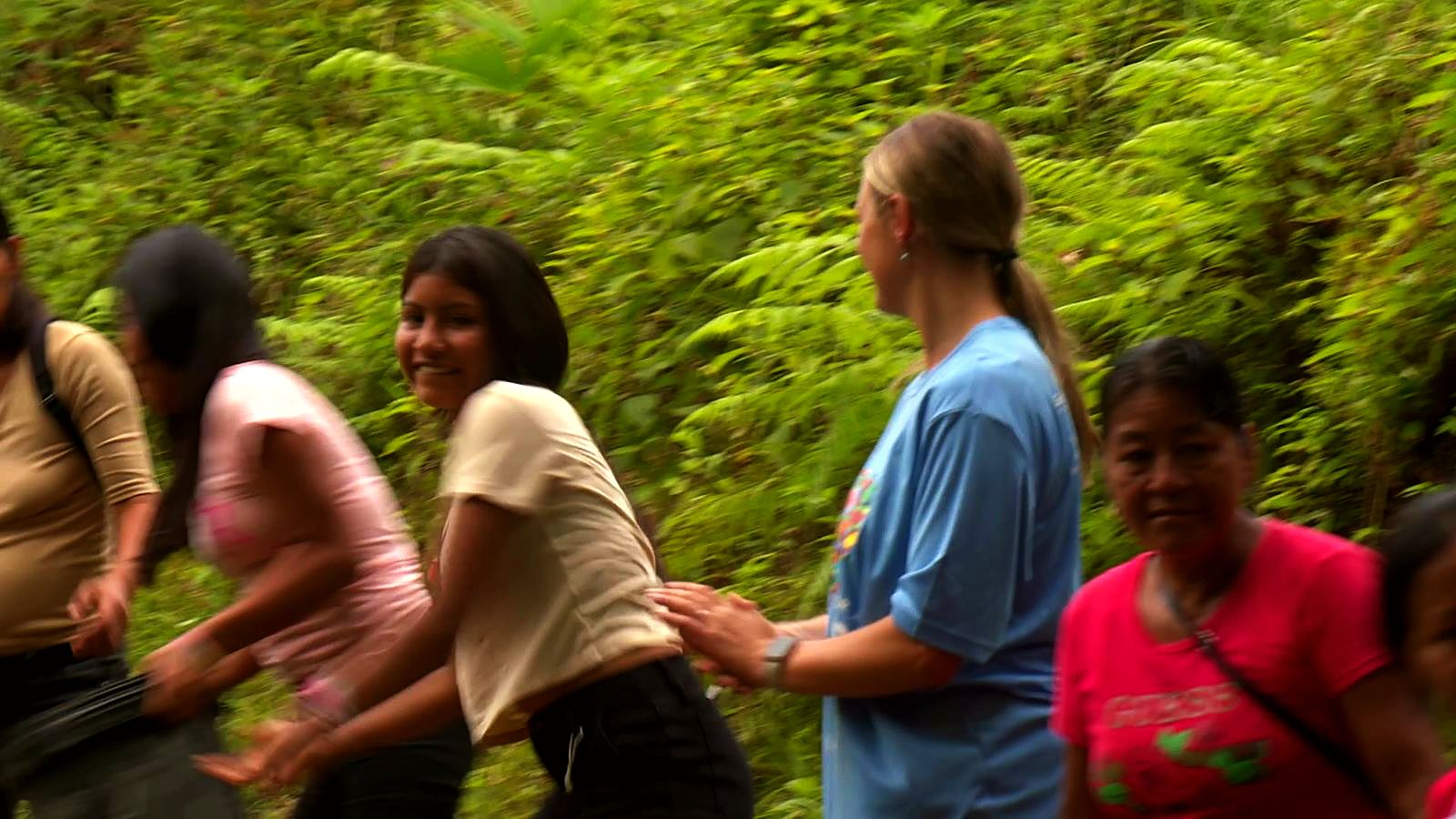 Villagers and volunteers passing buckets up a hillside