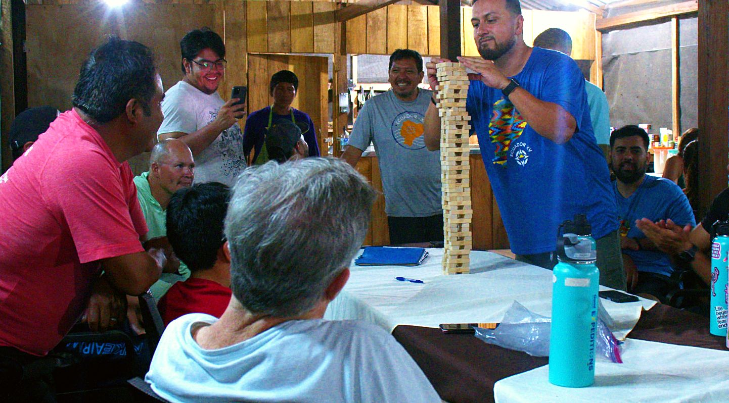 Local guides and the crew crowded around the Jenga tower