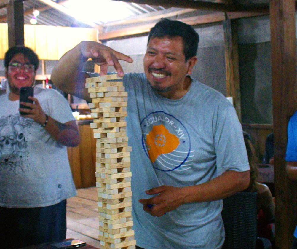 Sixto Tuston laughing beside a towering Jenga stack